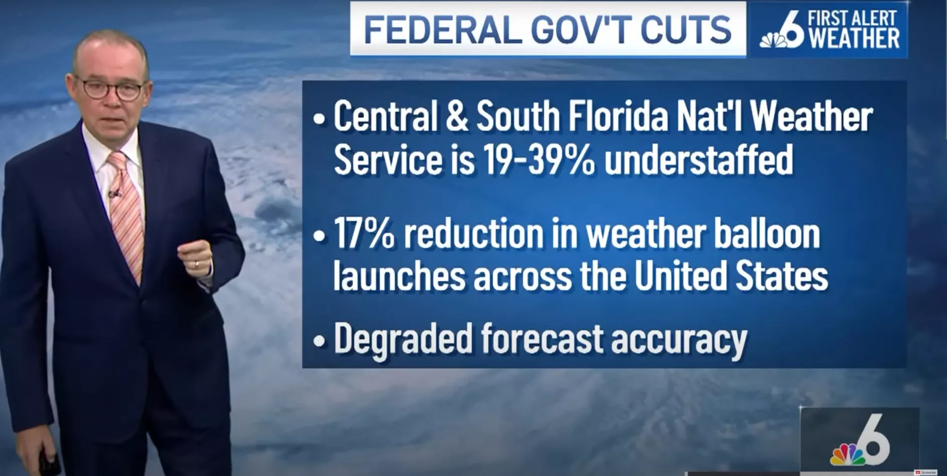 John Morales stands during his newscast with a graphic about the federal government cuts to climate research