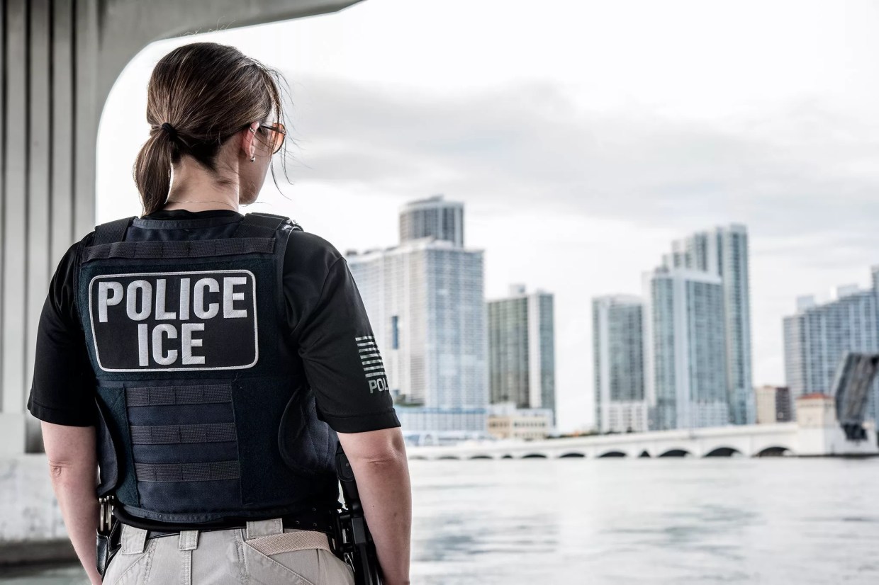 An ICE ERO officer looks out over the Miami skyline.